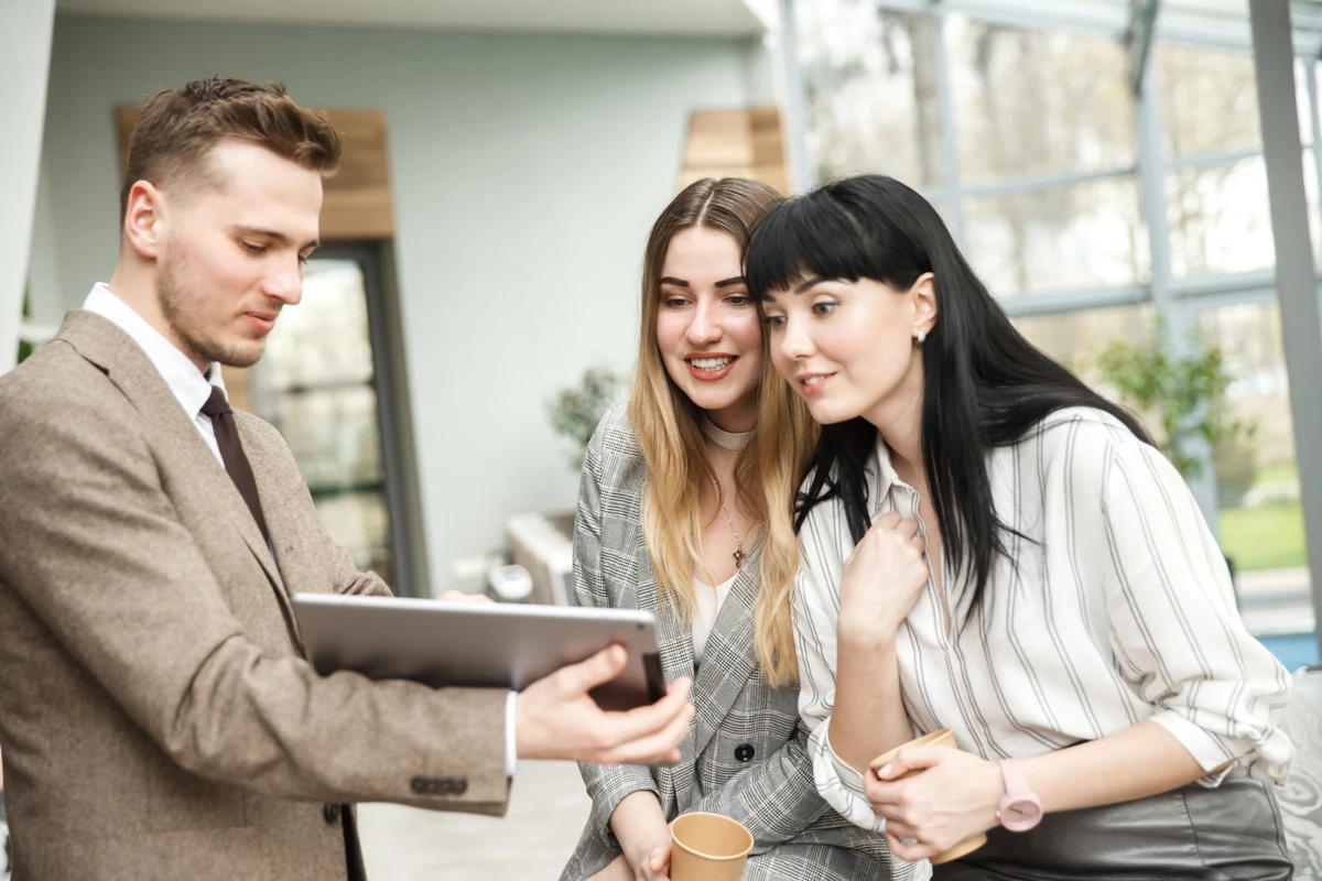 A property manager walking clients through details on a tablet